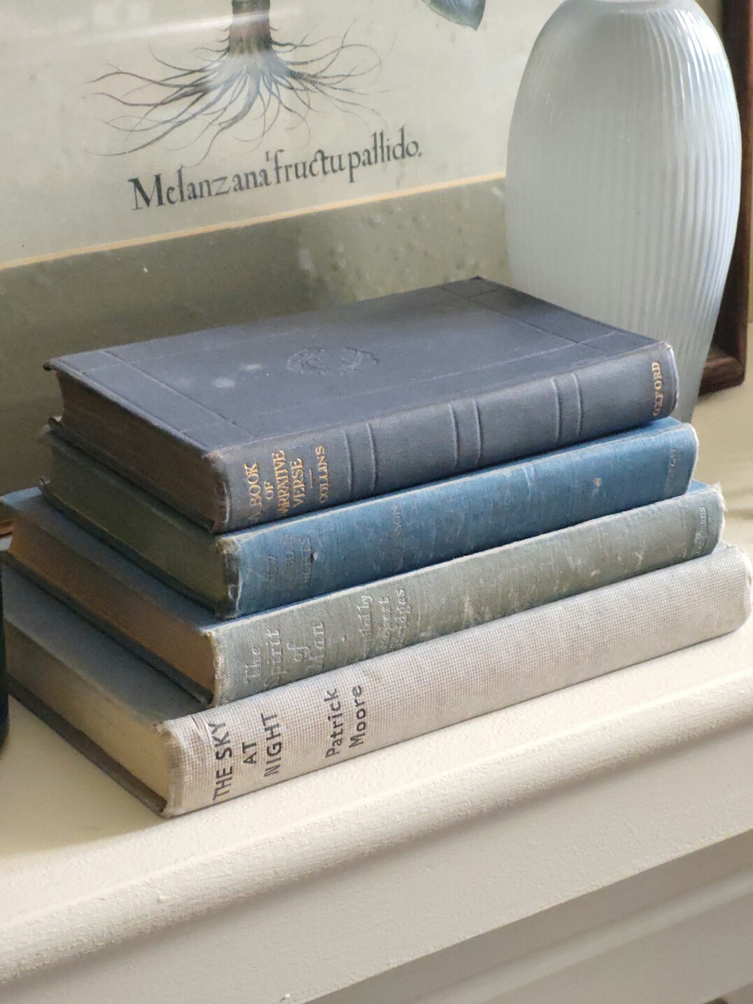 Stack of old books on a wooden table