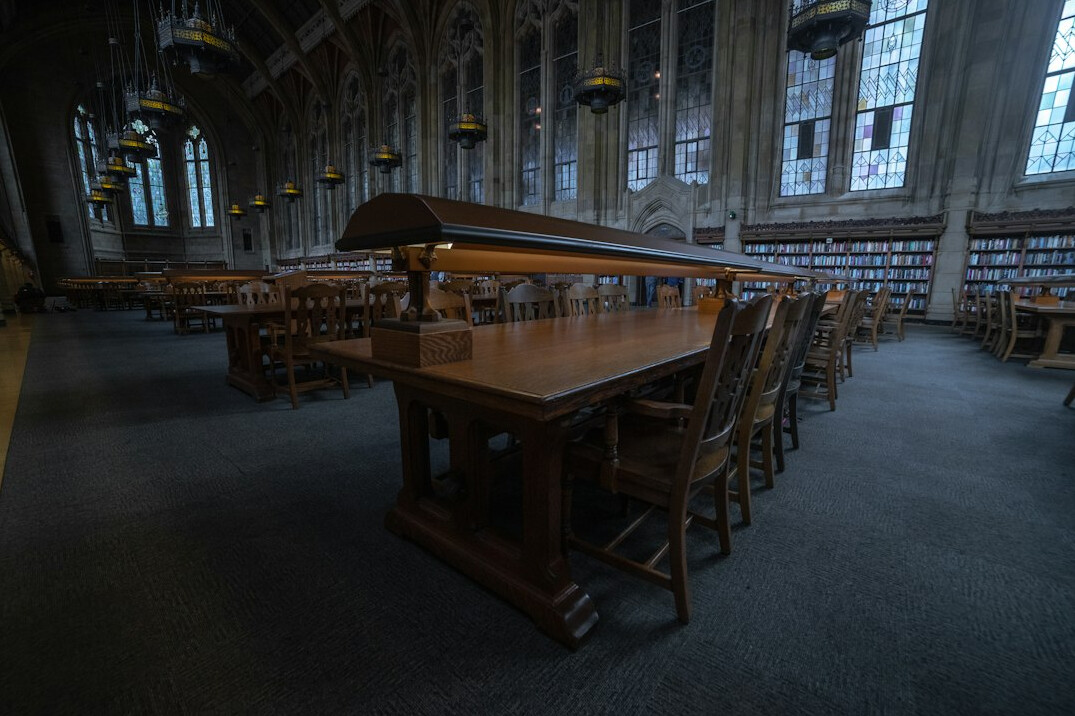 Quiet old library with tall wooden bookshelves and warm light